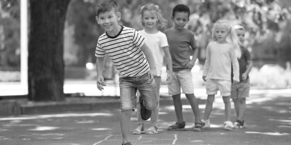 Little children playing hopscotch, outdoors